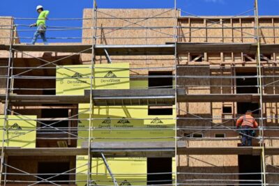 Construction workers walk on scaffolding around a new block of apartments, Aug.16, 2022, in Los Angeles.(FREDERIC J. BROWN/AFP/Getty Images)